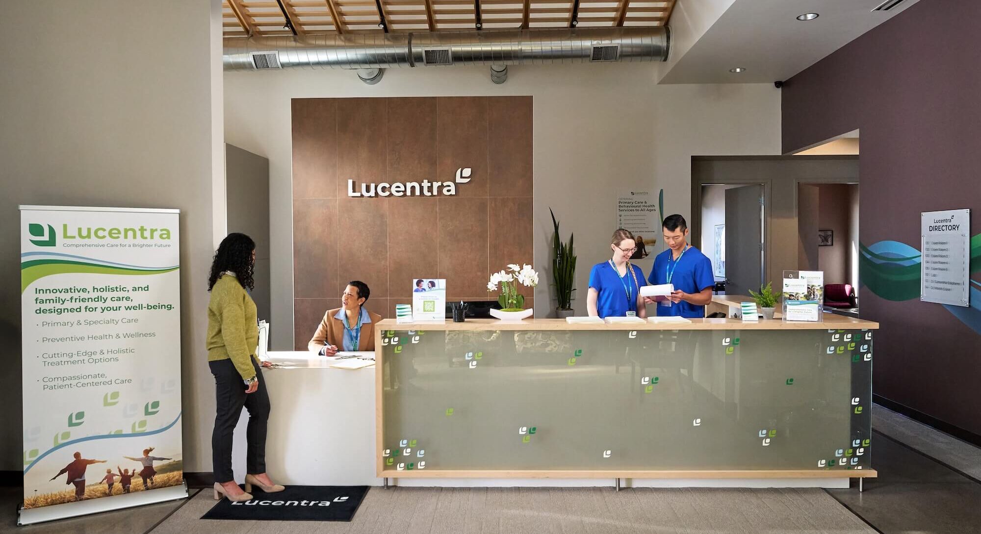 Lucentra reception area with staff assisting visitors, promoting holistic healthcare services.